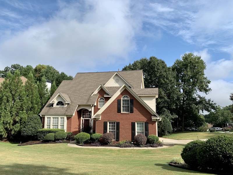 A traditional brick home on a wide lawn